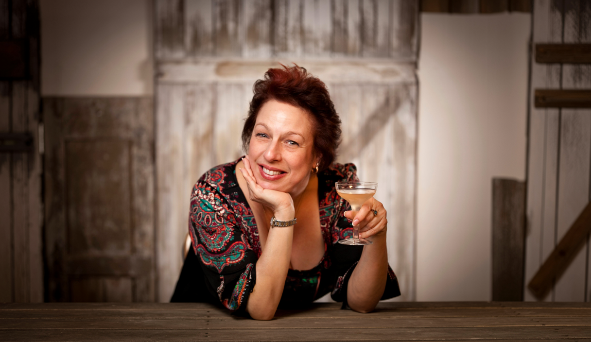 Katie Melynda Loeb holding a cocktail